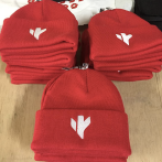 White embroderies on red winter caps